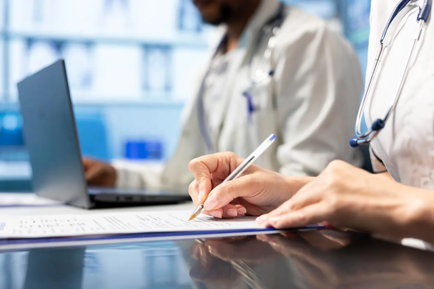 A healthcare professional reviewing documents at a desk