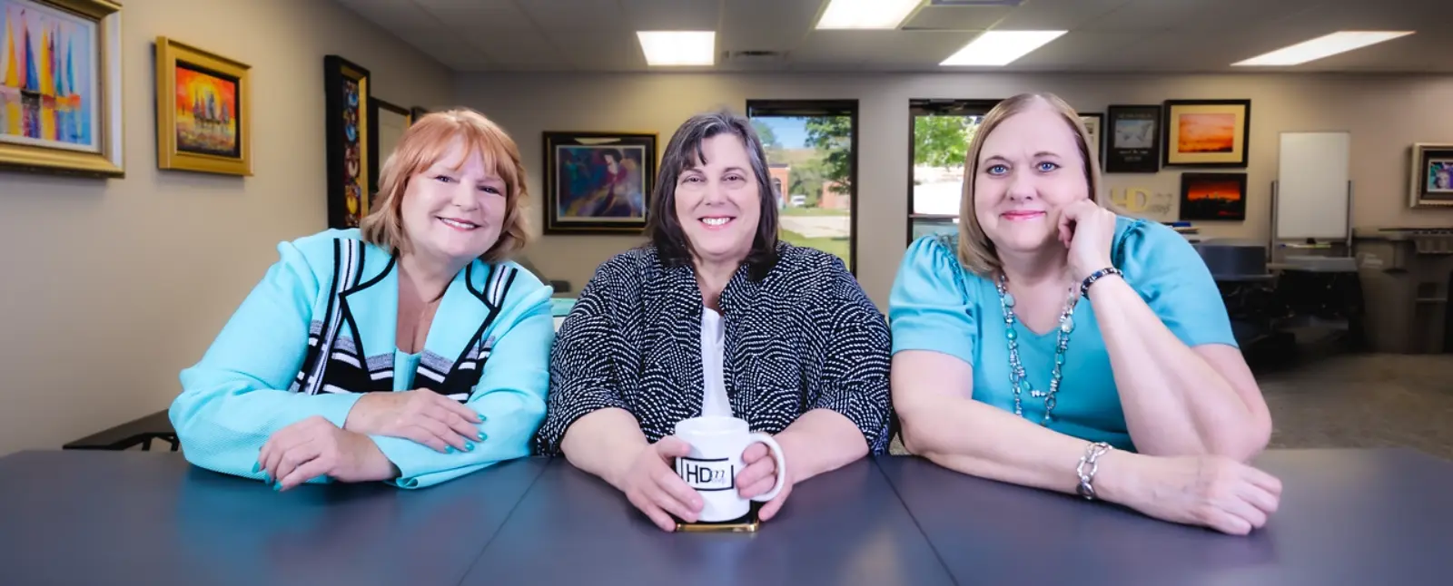 A small professional team collaborating at a desk