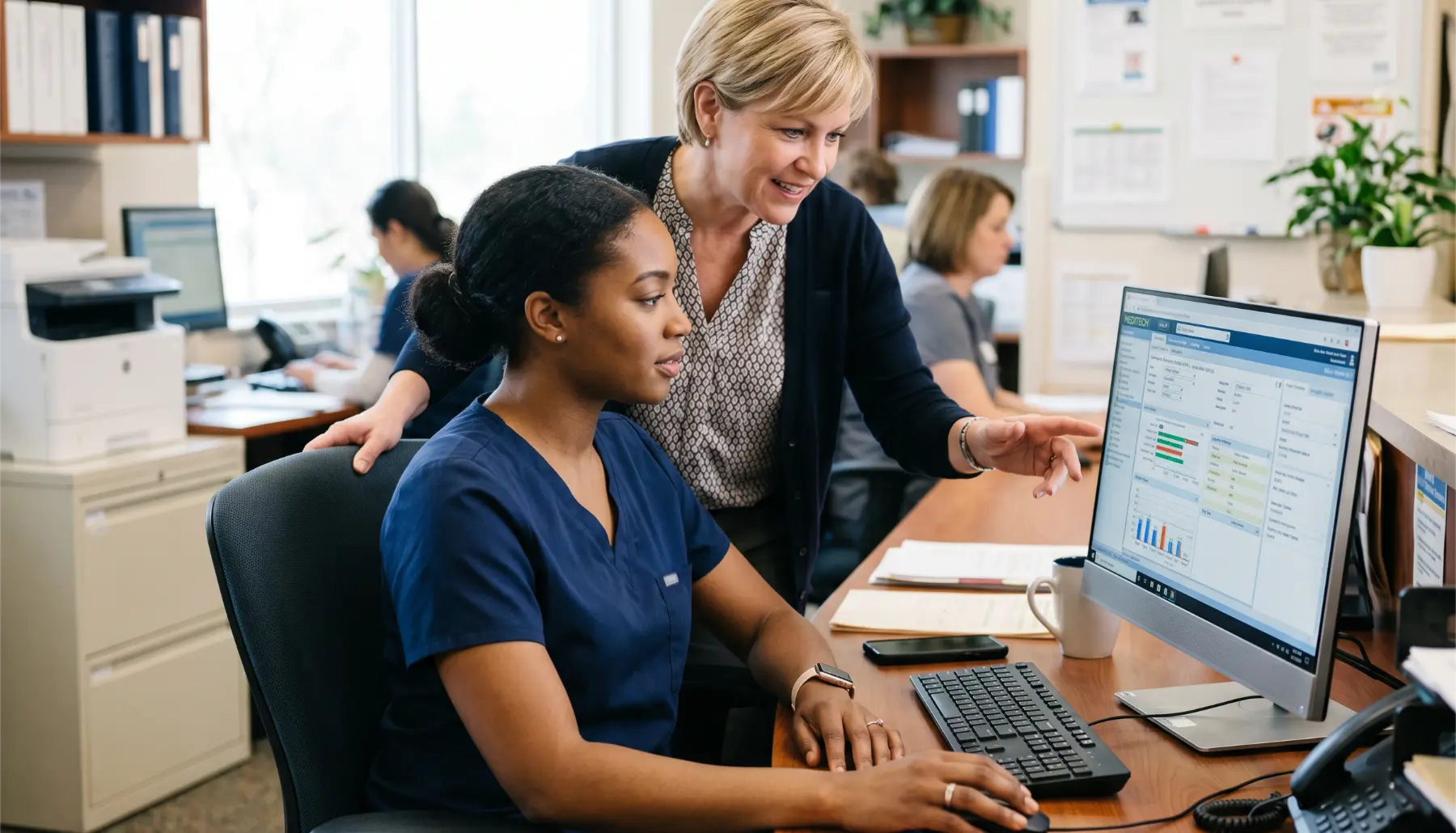 HDM specialist guiding a client through billing setup at a laptop