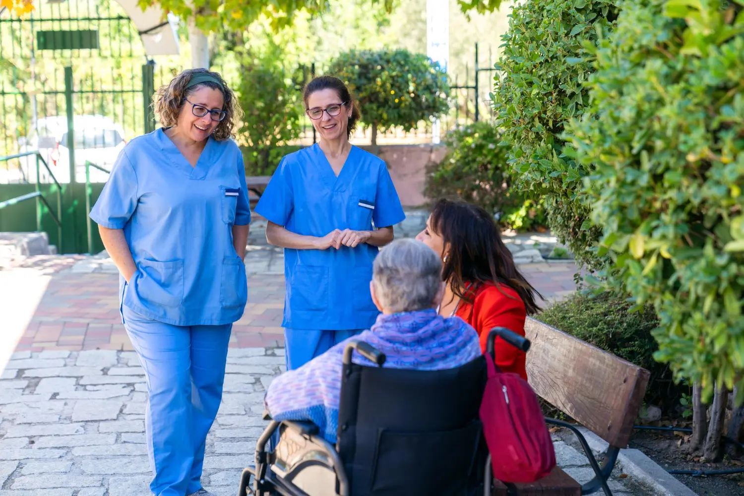 Caregiver gently holding the hand of an elderly patient at home
